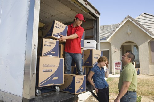 Local house movers helping with unloading at a Catford property